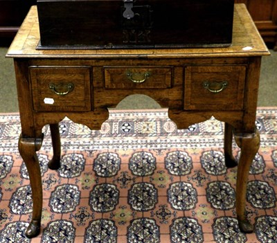 Lot 1307 - A George II cross banded oak lowboy