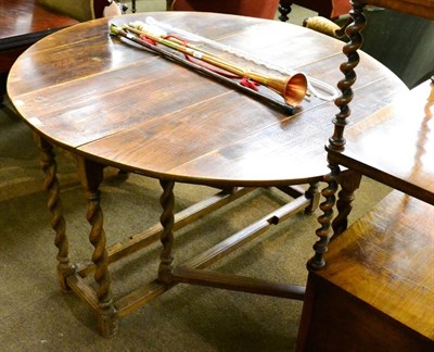 Lot 1311 - An oak gateleg dining table