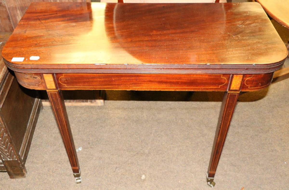 Lot 1312 - An inlaid mahogany fold over tea table