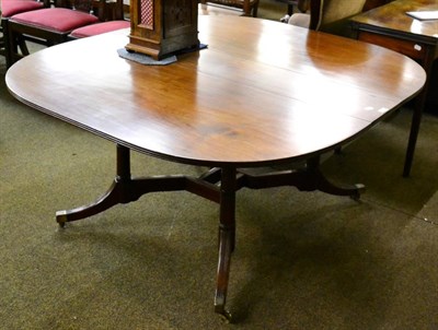 Lot 1315 - A George III mahogany drop leaf dining table, the D-end top raised on four tapering cylindrical...