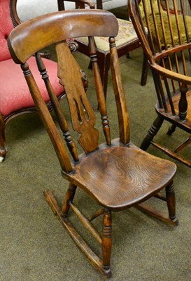 Lot 1328 - A 19th century oak and elm rocking chair with dish seat