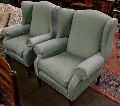 Lot 1341 - A pair of reproduction wing back armchairs