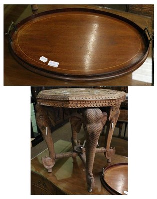 Lot 1354 - An Indian carved hardwood occasional table with elephant mask legs and inlaid with bone,...