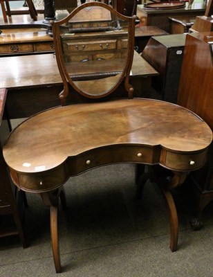 Lot 1370 - A 19th century mahogany reniform dressing table, fitted with a shield form mirror