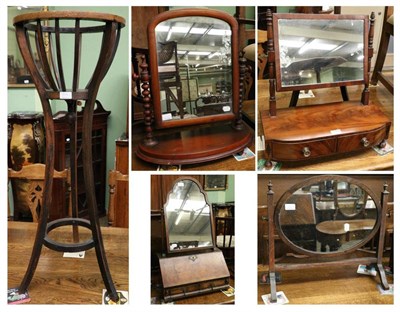 Lot 1374 - An oak basket form plant stand, together with four various 19th century toilet mirrors (5)