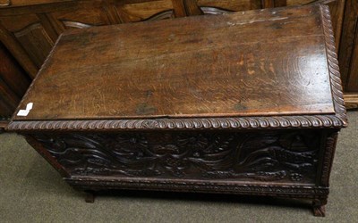 Lot 1375 - A reproduction carved oak coffer