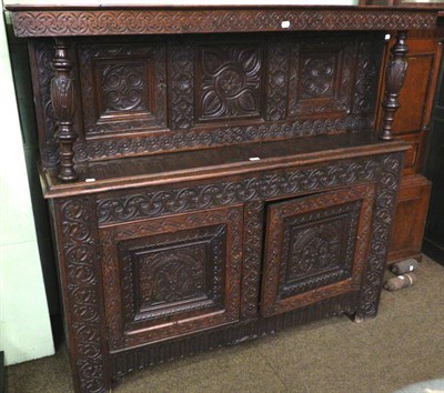 Lot 1389 - A heavily carved oak court cupboard, composed of period elements