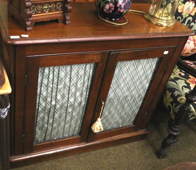 Lot 1399 - A mid 19th century mahogany two door cabinet with grille front