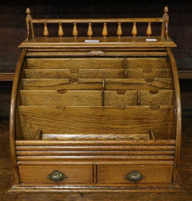 Lot 1410 - An early 20th century golden oak tambour fronted desktop correspondence box