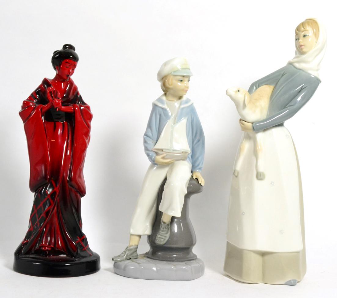Lot 181 - Two Royal Copenhagen figures and a Royal Doulton flambe Geisha figure (3)