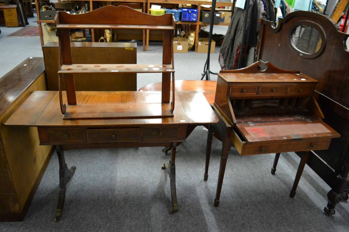 Lot 1181 - An Edwardian mahogany slant front writing desk, a Regency mahogany sofa table and a three tier...