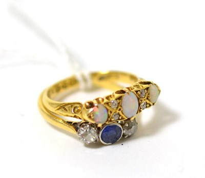 Lot 116 - An 18ct gold opal and diamond ring and a sapphire and diamond three stone ring