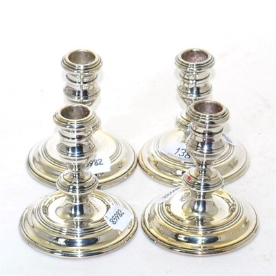 Lot 138 - A set of four silver dwarf candlesticks