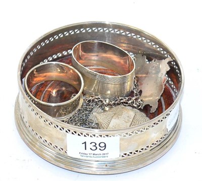 Lot 139 - A group of silver including a coaster with turned wooden base, a set of three shell form...