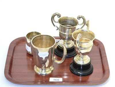 Lot 168 - Two silver trophies on stands, together with a silver Christening mug and a silver tankard