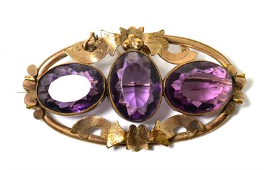 Lot 245 - A Victorian yellow metal brooch set with three purple paste stones