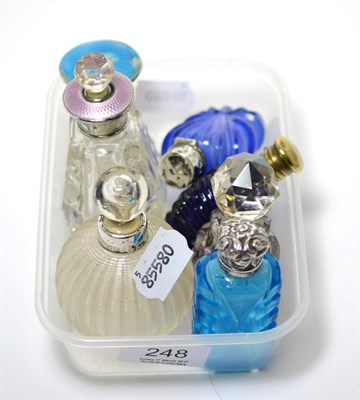 Lot 248 - A group of seven various coloured glass, enamel topped and other scent bottles