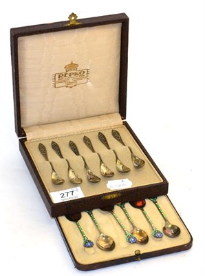 Lot 277 - A cased set of silver coffee spoons with floral enamel decoration and a set of cased German...