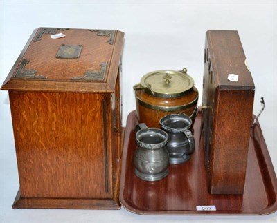 Lot 293 - An early 20th century oak smoker's cabinet; with a Smith's wallclock; biscuit barrel and two pewter