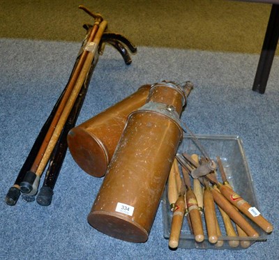 Lot 334 - A collection of woodworking chisels, a bundle of walking sticks and two copper water carriers