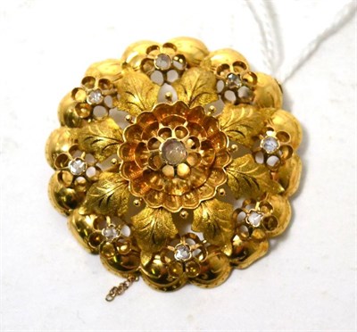 Lot 336 - A diamond set brooch, a cut diamond in a yellow rubbed over setting within a flower and leaf...