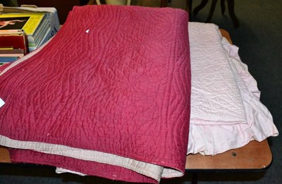 Lot 1071 - Pale pink reversible quilt with frilled trim, another in red with cream reverse (2)