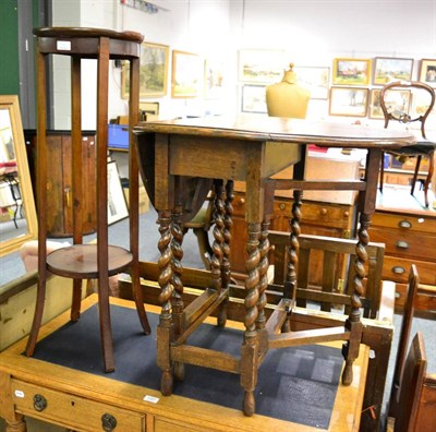 Lot 1090 - An oak drop leaf occasional table and a two tier plant stand