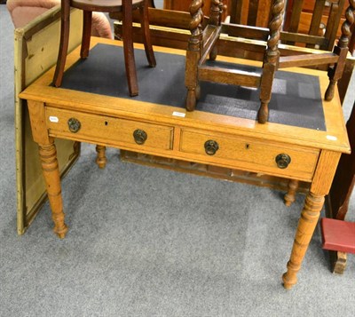 Lot 1091 - An oak writing table with leather insert