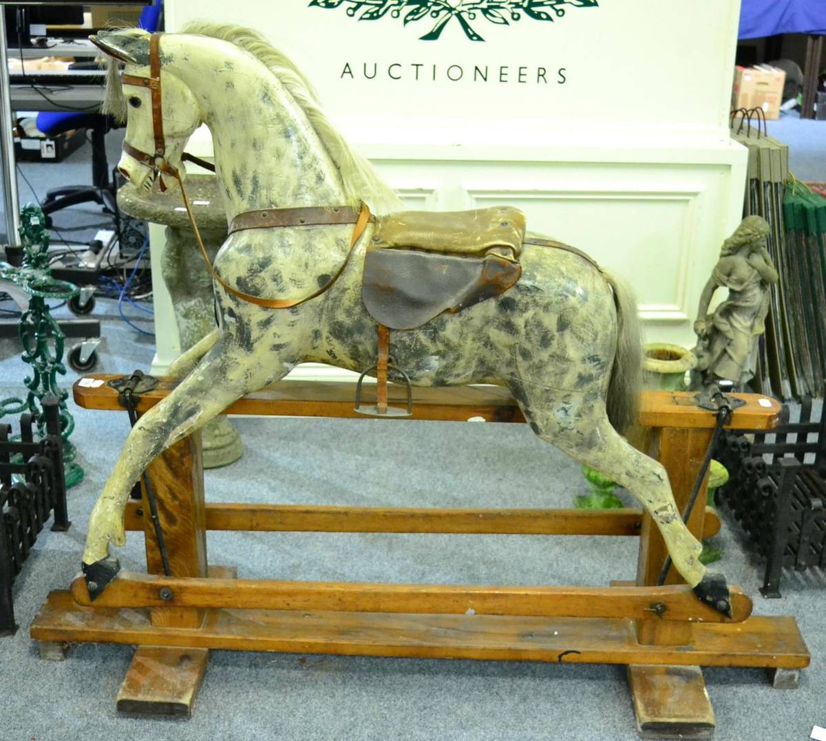 Lot 1093 - An early 20th century painted carved wood rocking horse on trestle base