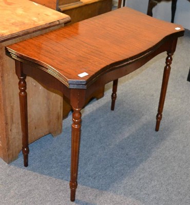 Lot 1140 - A reproduction leather topped fold over table and a reproduction sofa table