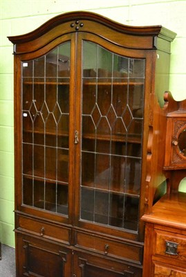 Lot 1265 - An oak bookcase with leaded glass doors