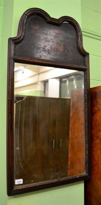 Lot 1268 - A walnut mirror with painted panel