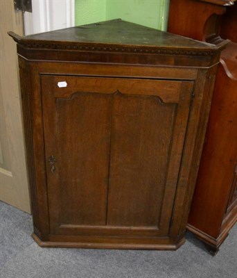 Lot 1270 - A George III oak corner cupboard