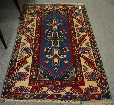 Lot 1300 - A Dofemalti rug, West Anatolia, the pale indigo field with three stylised flower heads, enclosed by