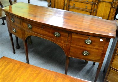 Lot 1337 - A George III mahogany bow fronted sideboard (88cm by 162cm by 54cm) together with a fretwork mirror