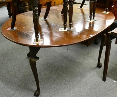 Lot 1338 - An 18th century mahogany gateleg table with carved base