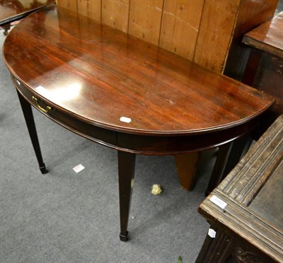 Lot 1341 - A George III mahogany demi lune hall table fitted with a drawer