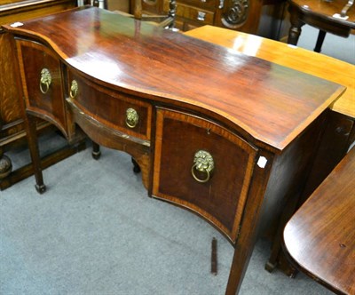 Lot 1344 - A late George III mahogany and cross banded serpentine sideboard