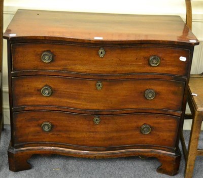 Lot 1386 - A George III mahogany serpentine fronted three height chest of drawers