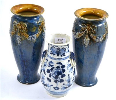 Lot 117 - A pair of Royal Doulton stoneware vases and a Japanese blue and white vase (3)