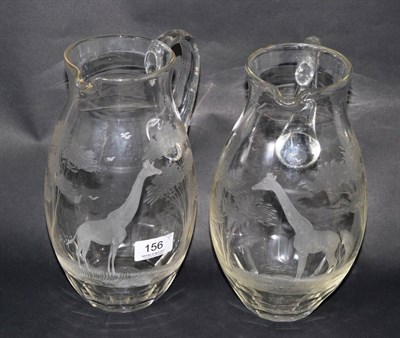 Lot 156 - A near pair of engraved Rowland Ward giraffe glass jugs (2)