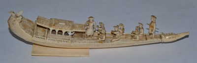 Lot 177 - An Indian carved ivory model of a boat with eight figures, late 19th century