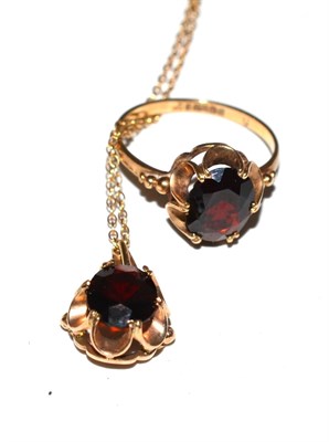 Lot 235 - A 9ct gold garnet set ring, together with matching pendant on chain