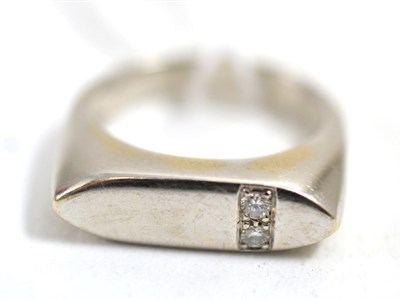 Lot 287 - A diamond ring, the flat torpedo shaped head set to one side with two round brilliant cut...