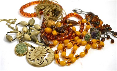Lot 292 - A faceted amber bead necklace, a simulated amber and filigree necklace and earrings suite, a...