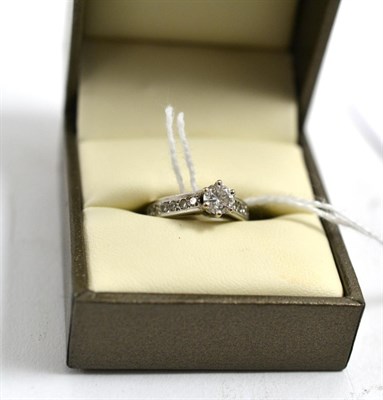 Lot 319 - A diamond solitaire ring with diamond set shoulders, total estimated diamond weight 0.65 carat...