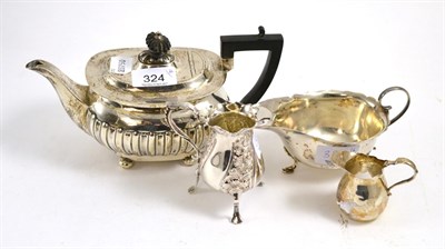 Lot 324 - Walker & Hall silver teapot, a Mappin & Webb silver sauce boat and two silver cream jugs