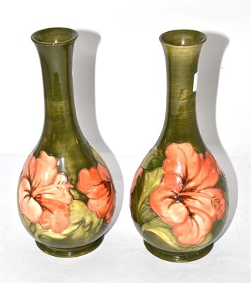 Lot 326 - A pair of Moorcroft pottery Hibiscus pattern bottle vases