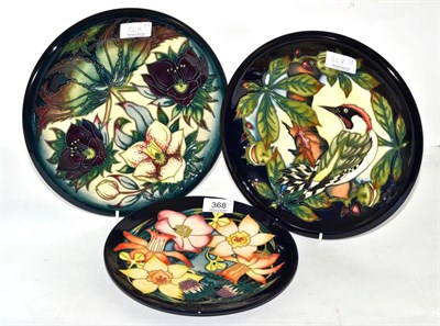 Lot 368 - Two modern Moorcroft plates, 'Ingleswood' and 'Hellebore' pattern, 26cm diameter, together with...