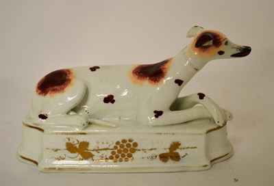 Lot 430 - A 19th century Staffordshire model of a recumbent hound